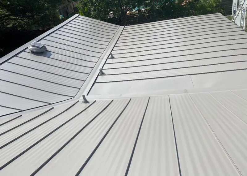 Solar attic fan installed on a metal roof for Roof Ventilation in Fort Madison